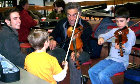 Keith teaching some boys to fiddle